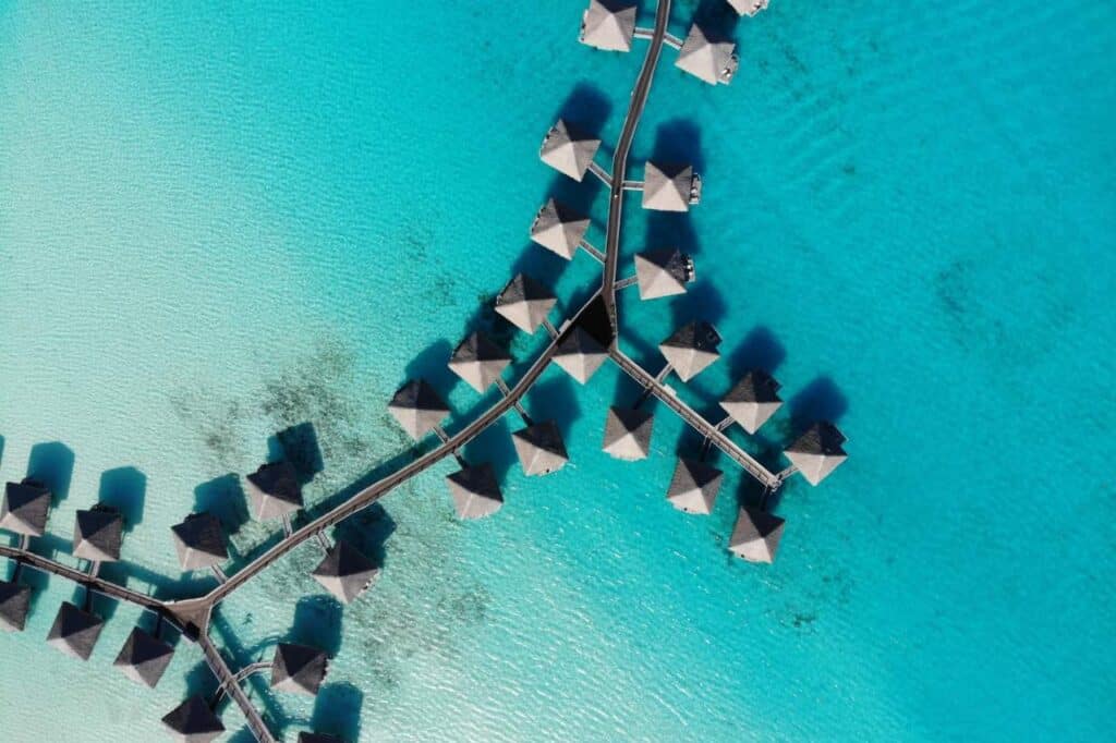 aerial view of overwater villas in turquoise lagoon bora bora french polynesia honeymoon
